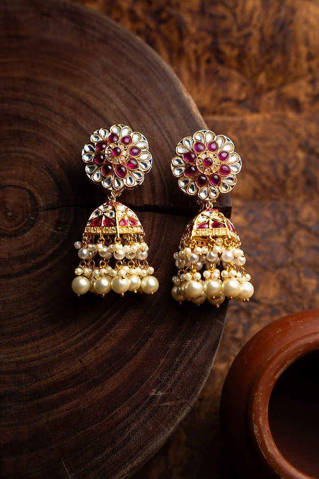 Jadau jhumkaas With pearls And a polkie finish And semi precious stones,